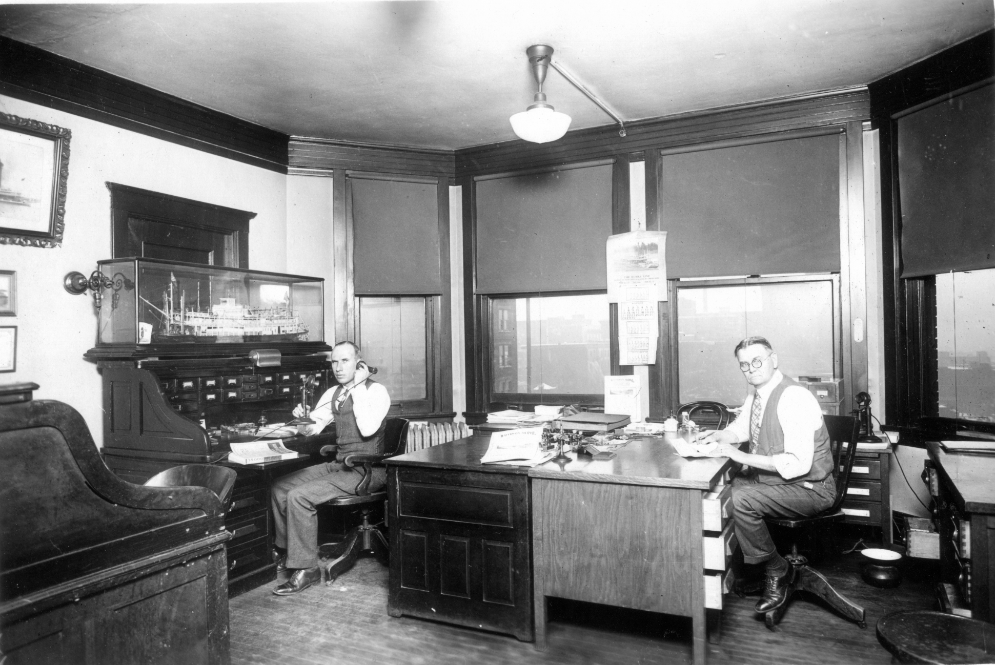 (Image: Donald T. Wright and Sam Smith seated at desks)