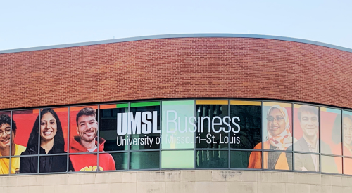 picture of the brick and stone anheuser busch hall at umsl with a graphic of students on the windows