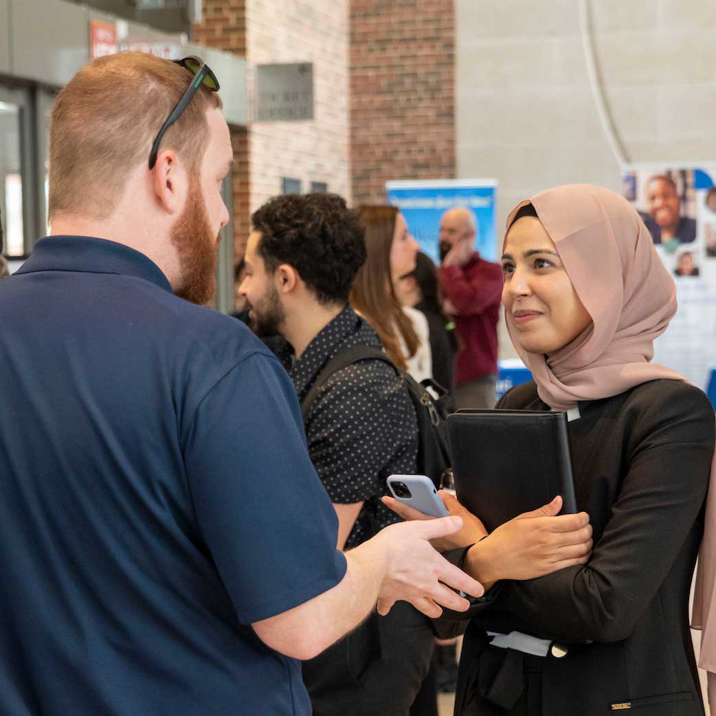 Student speaks with employer at a career fair
