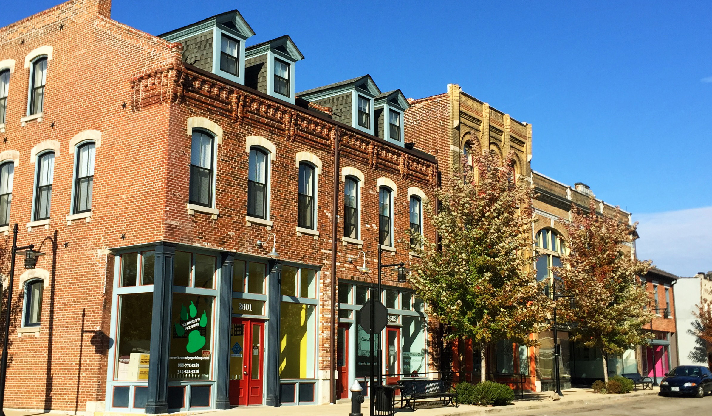 Brick building with colorful storefronts