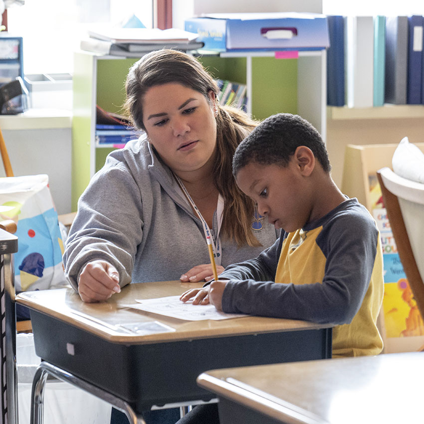 teacher with an elementary student