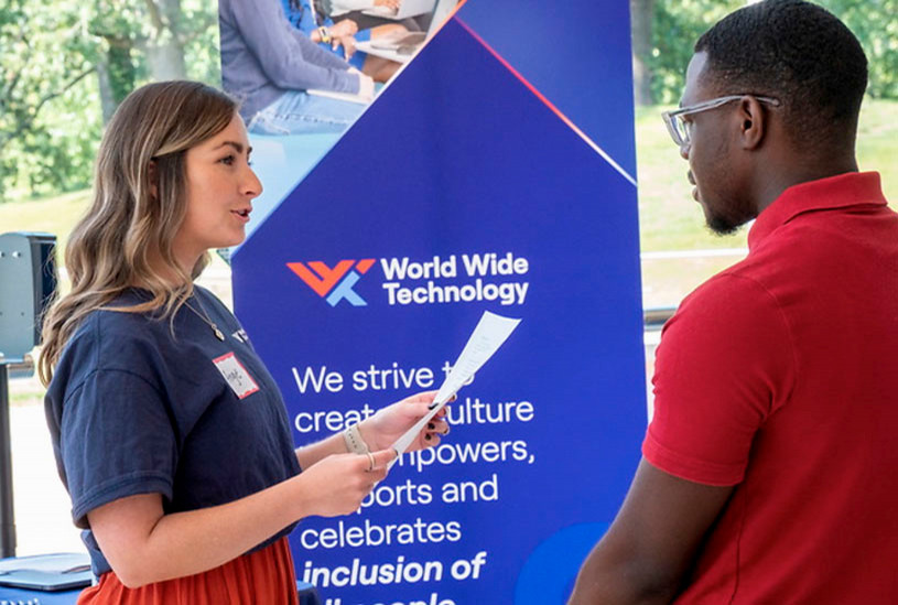 student talking to an employer at a career fair