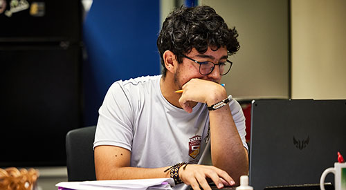 male student working on a computer