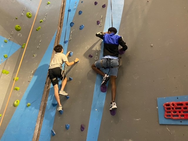 Students on indoor rock climbing wall