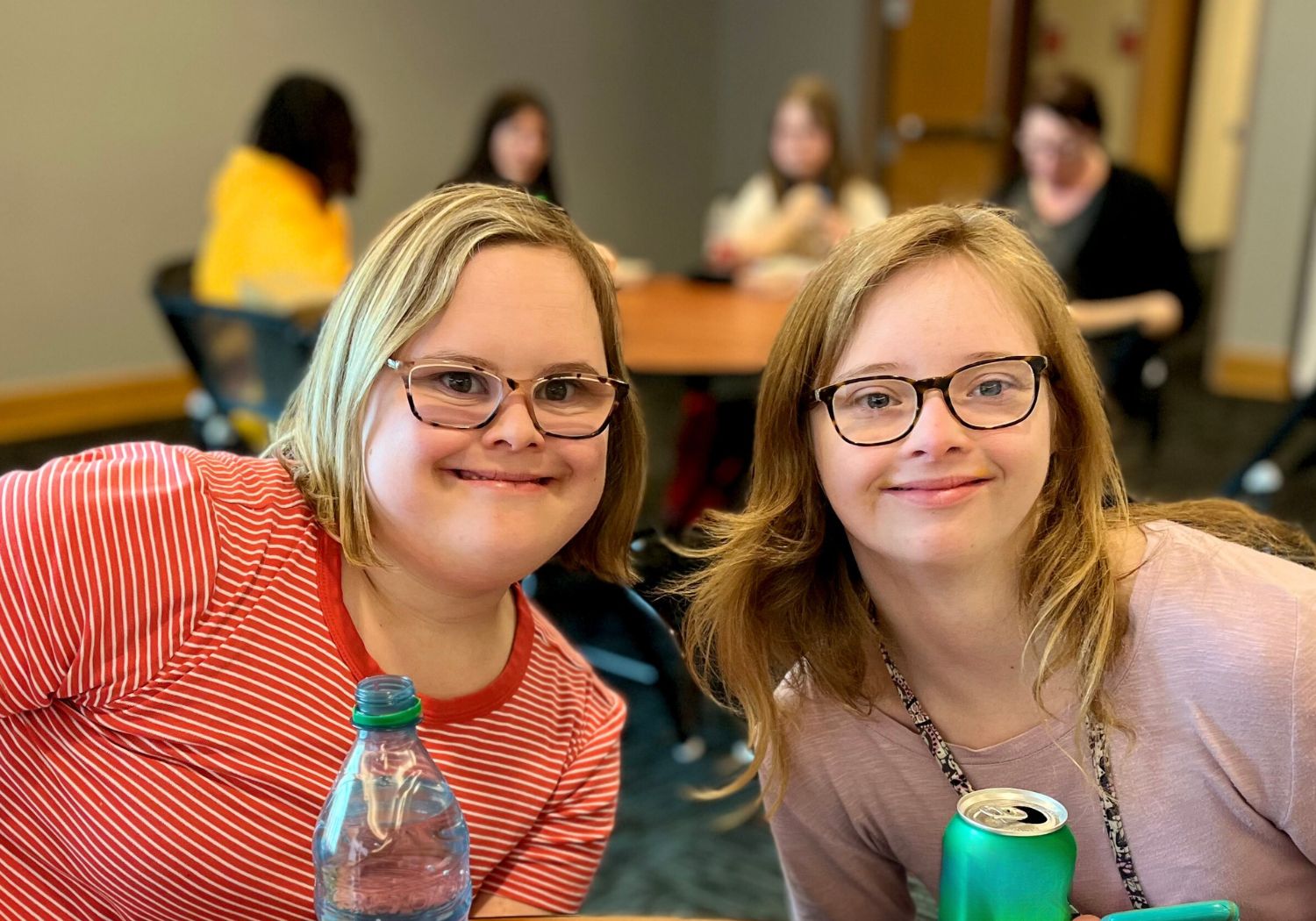 Two neurodiverse female students smiling