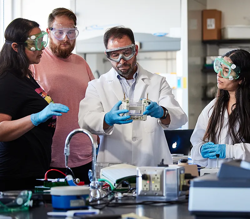 Chemistry students surroundnig instructor