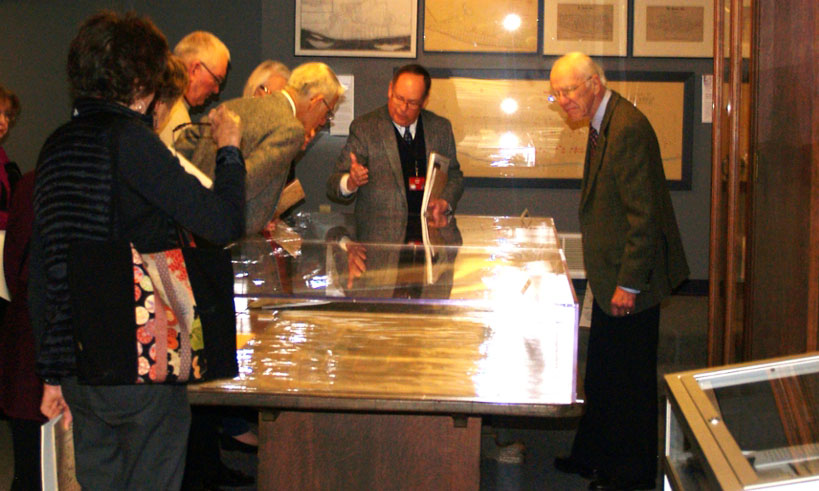 a tour group around a case