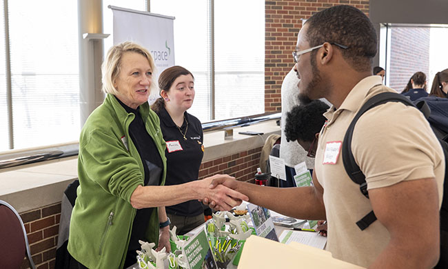 student shaking an employers hand