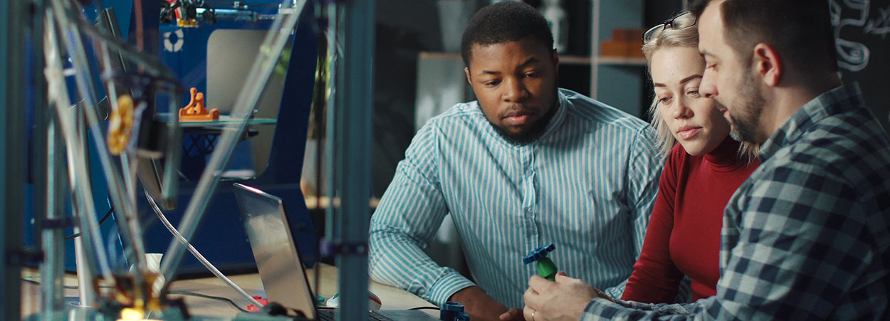 three people working on mechanical engineering 