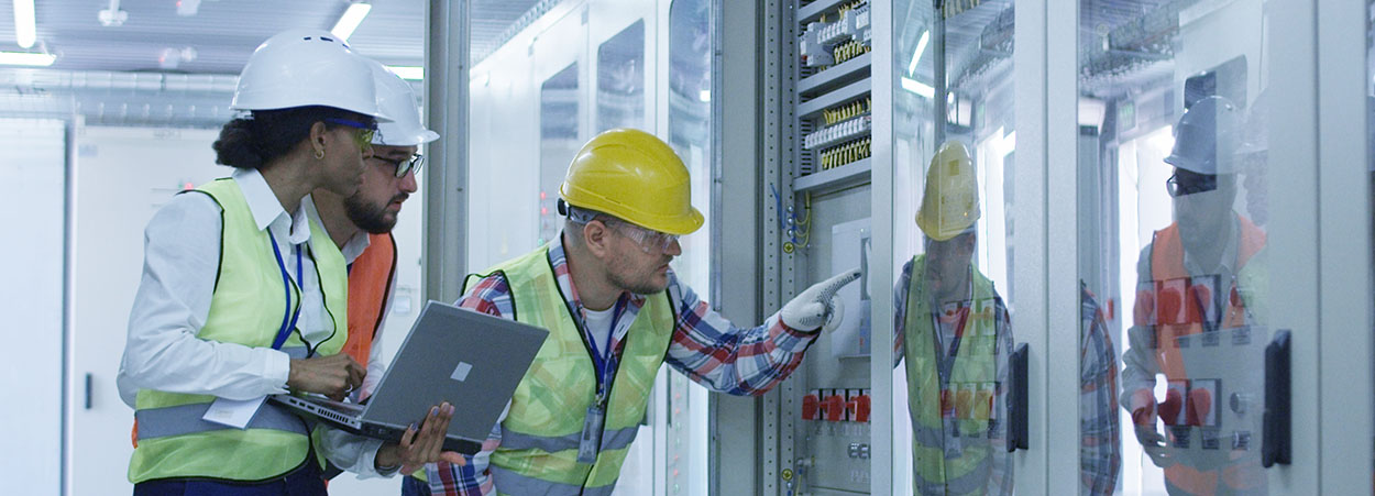 three people working on electrical issue