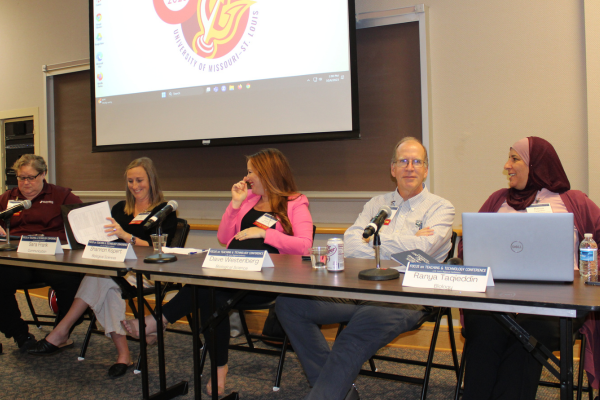 Conference panelists chatting before their session begins