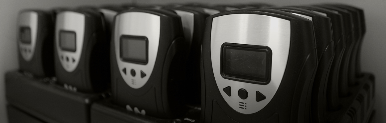 Personal Assistive Listening Devices charging on a shelf