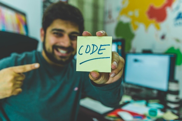 Picture of person holding note saying code