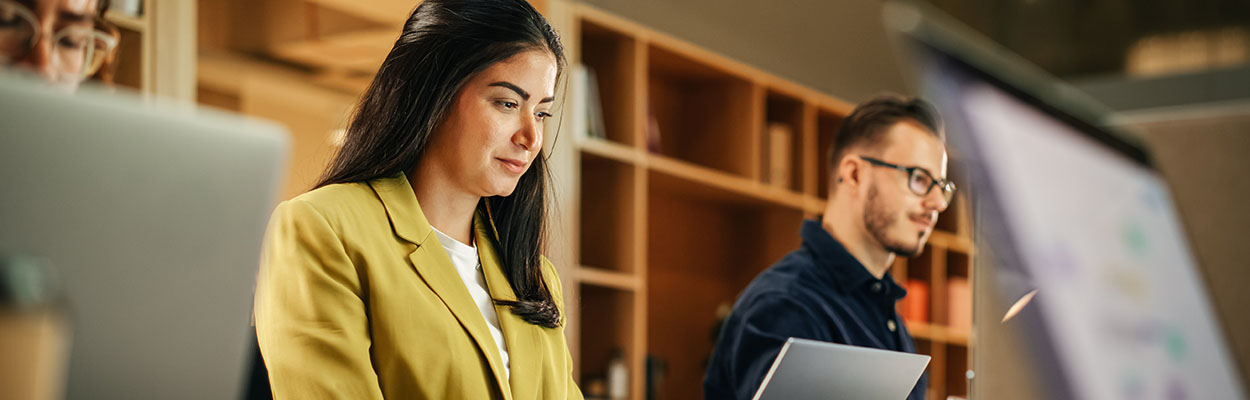 Woman in professional blazer on a computer