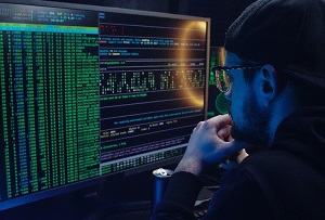 Picture of person in front of computer looking at code